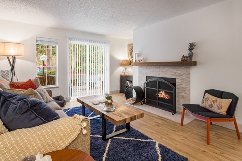a living room with a fireplace and a couch and a coffee table